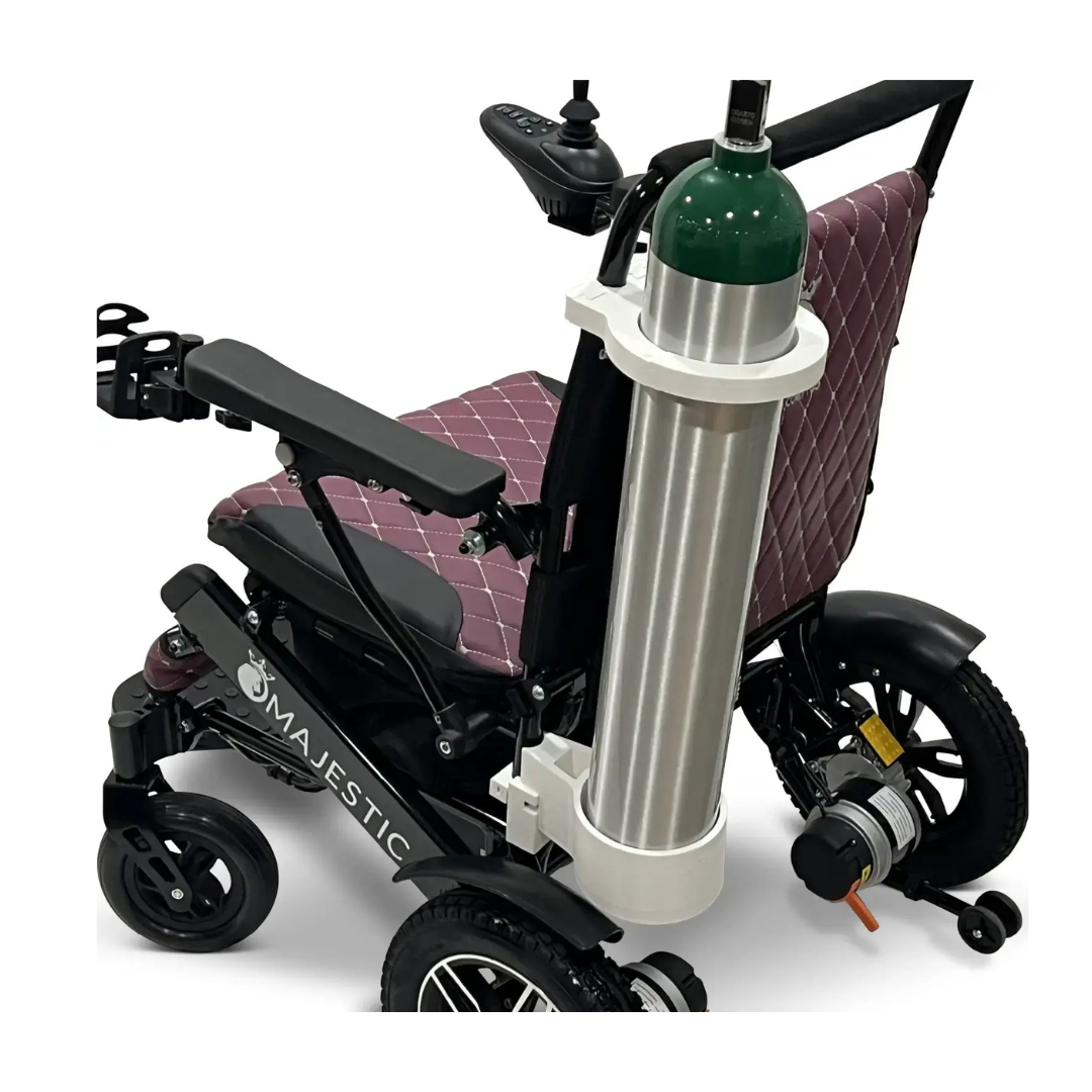 A Quick Detach Oxygen E Tank Holder for ComfyGo Powerchairs is securely mounted behind the maroon quilted seat, holding a large oxygen cylinder.